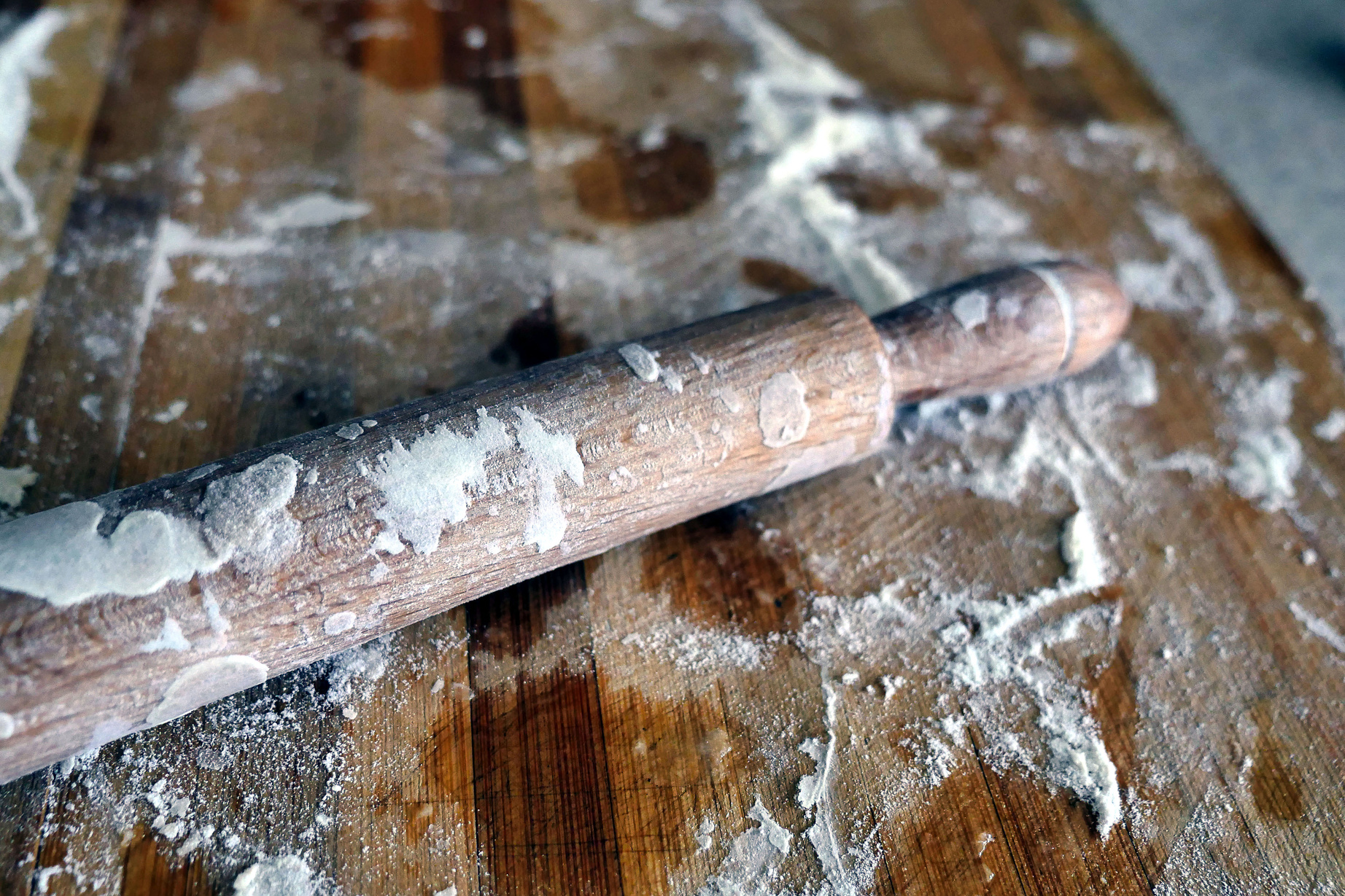 dough roller on a floured floor, wooden roller