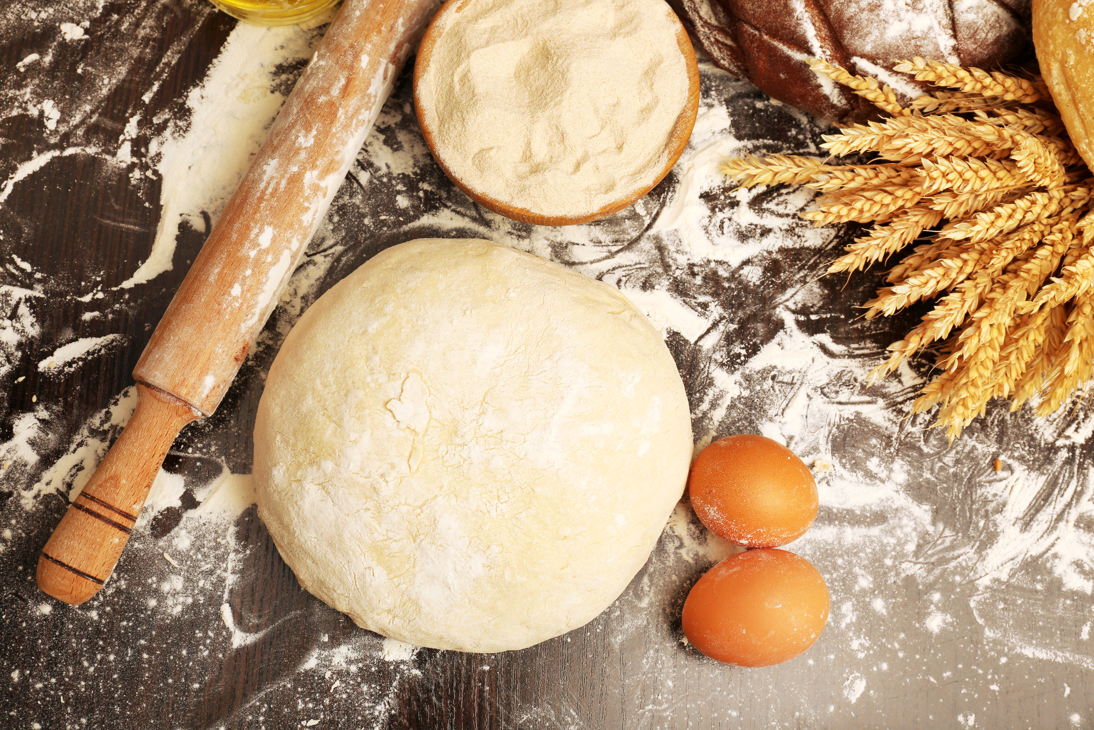 Dough with Baking Ingredients and Wooden Roller on Table